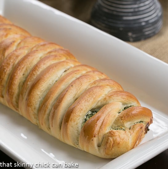 Uncut Spinach and Onion Braid on a white ceramic tray