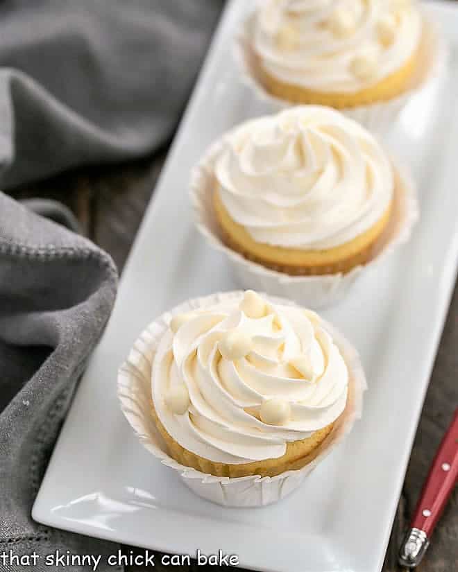 Vanilla Cupcakes with White Chocolate Buttercream on a rectangular ceramic tray.