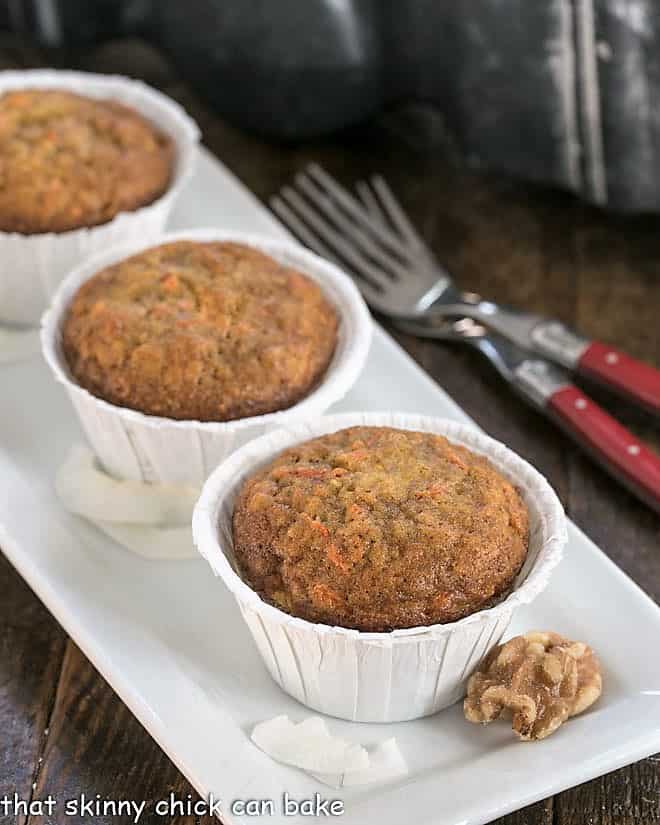 Cream Cheese Filled Carrot Cake Muffin in white cupcake liners on a white platter.