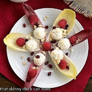 Overhead view of a star of Endive Cups with Blue Cheese, Raspberries and Macadamia Nuts