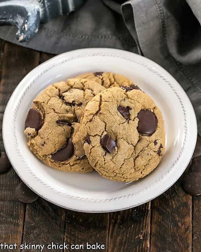 Overhead view of jumbo chocolate chip cookies on a white plate