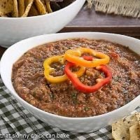 Smoky Black Bean Dip in a white bowl topped with fresh bell pepper rings