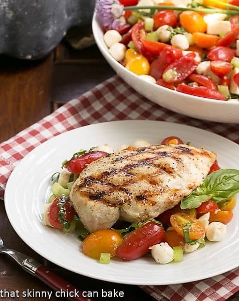 Grilled chicken breast over a Caprese Salad with Chicken