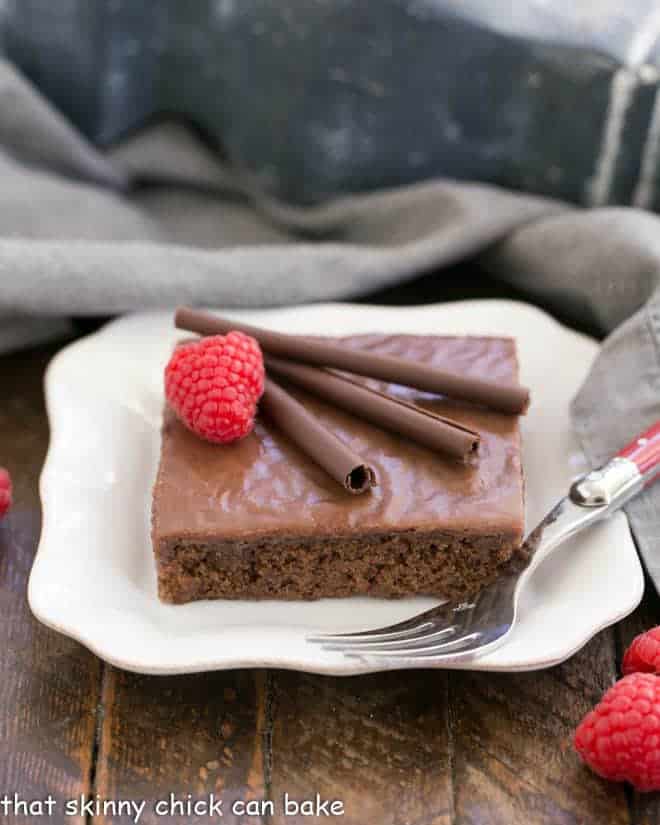 Chocolate Syrup Brownies on a square white plate with a fork.