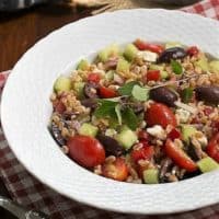 Greek Farro Salad from in a white basketweave bowl