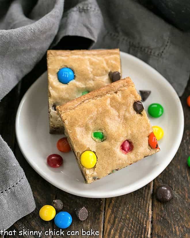 Overhead view of two M & M Blondies on a round white plate