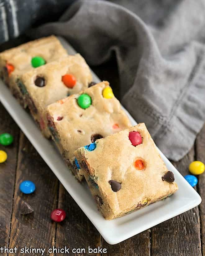 M & M Blondies on a narrow white tray.