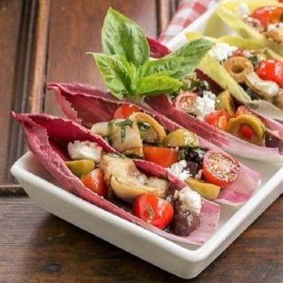 Close view of Mediterranean Endive Boats in a white, rimmed serving tray