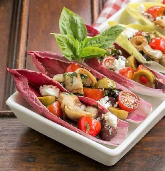Close view of Mediterranean Endive Boats in a white, rimmed serving tray