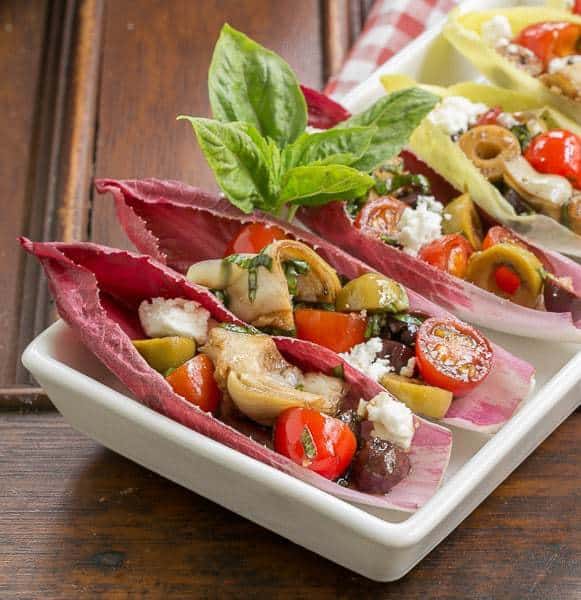 Close view of Mediterranean Endive Boats in a  white, rimmed serving tray