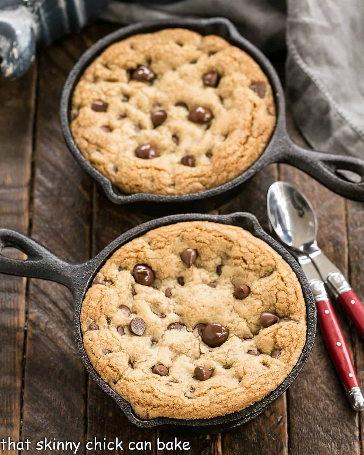 Overhead view of 2 pizza cookies in cast iron skillets.