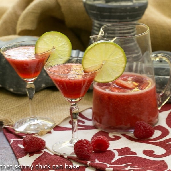 Berry Daiquiris in martini glasses garnished with lime slices