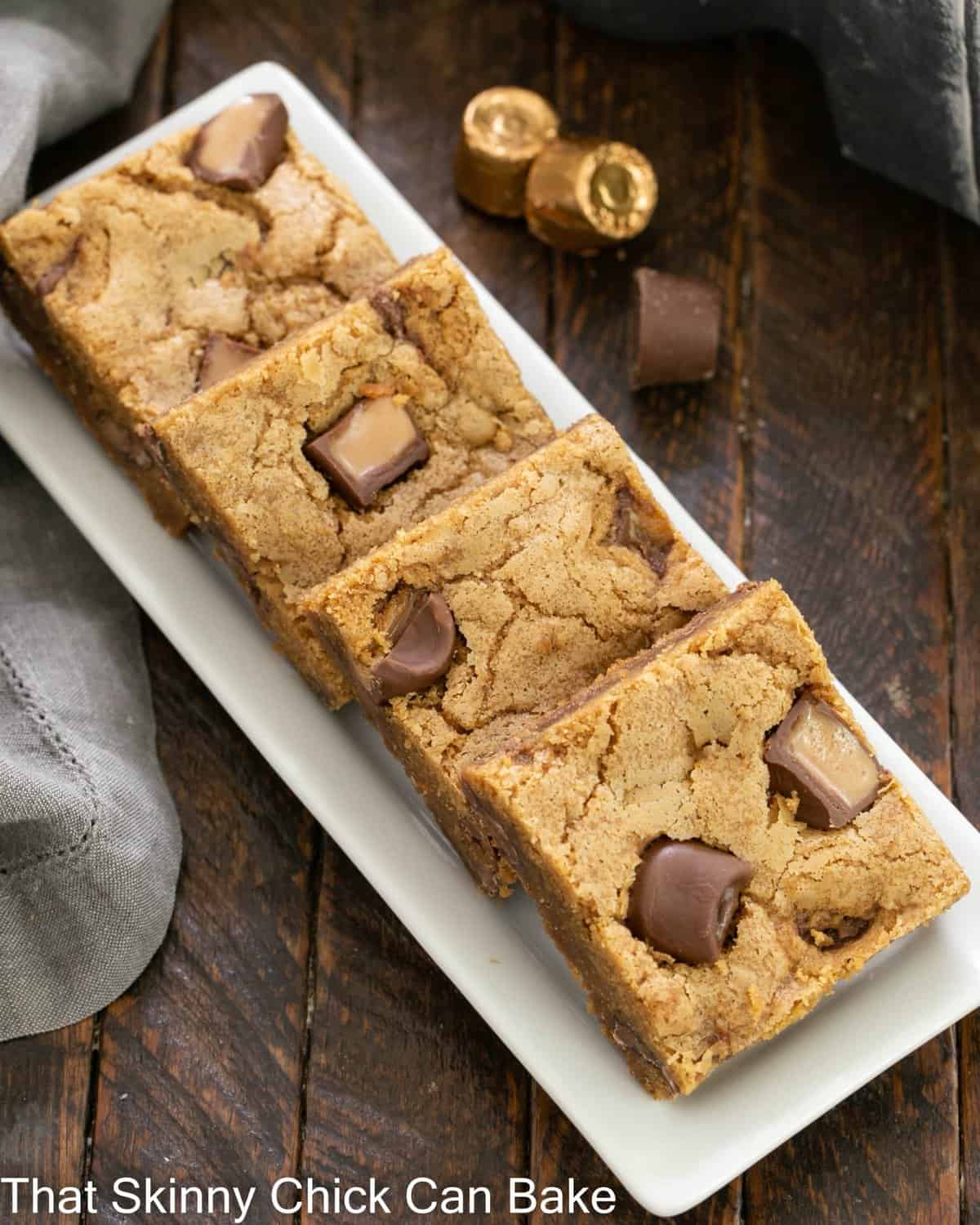 Overhead view of a tray of Biscoff squares on a white ceramic tray.