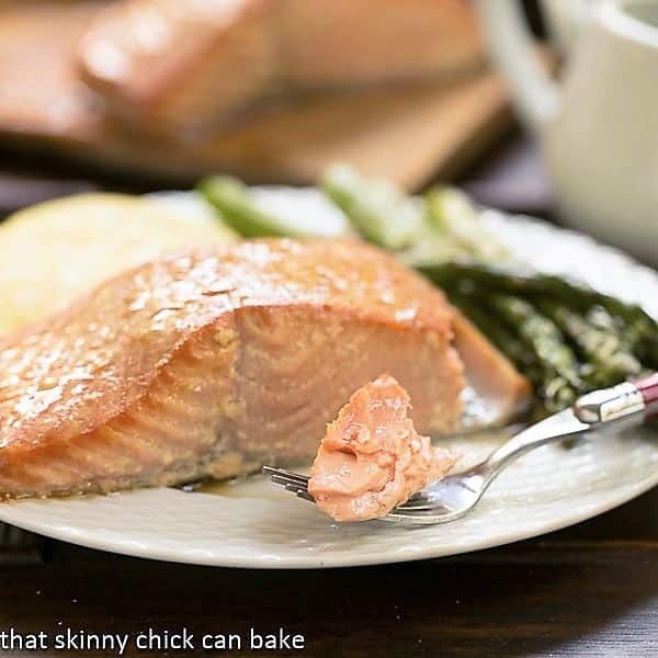 Grilled Cedar Plank Salmon on a plate i with a bite on a fork