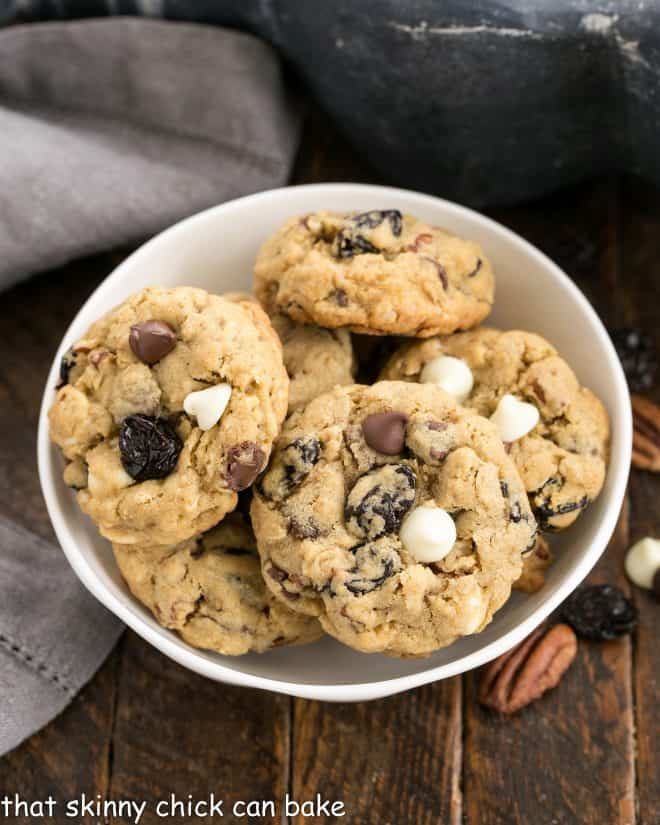 Overhead view of Oatmeal, Cherry and Chocolate Chip Cookies in a white ceramic bowl