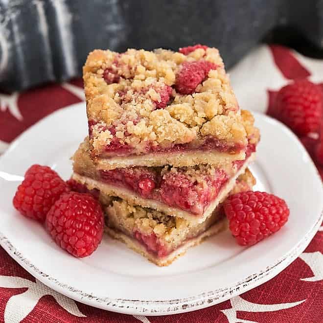 Stack of Streusel Topped Raspberry Cookie Bars on a small round white plate