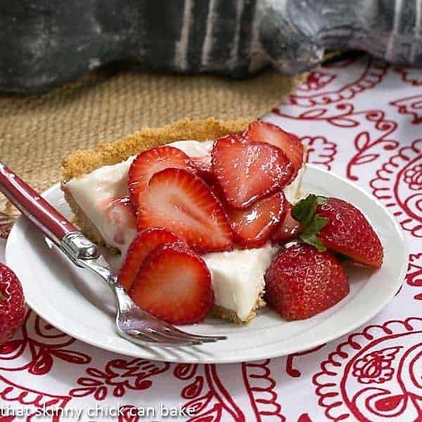 Slice of Strawberry Cheesecake Ice Cream Pie on a white dessert plate