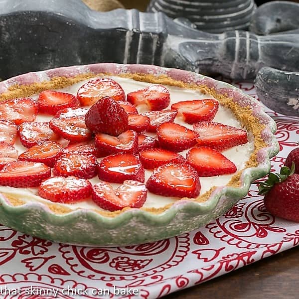 Strawberry Cheesecake Ice Cream Pie in a green and pink pie plate