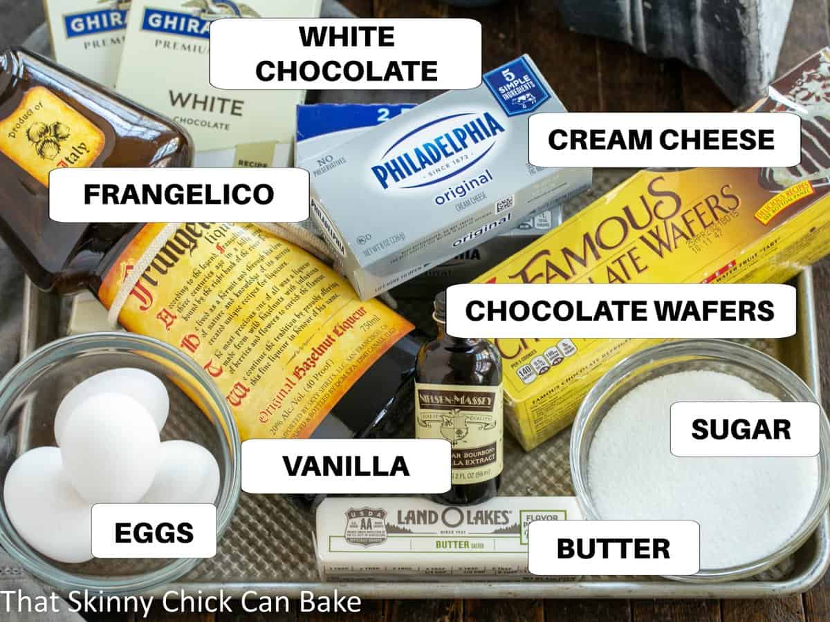 White chocolate cheesecake ingredients on a sheetpan with labels.