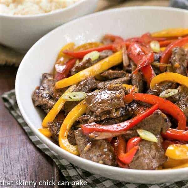 Asian Beef with Peppers in a white serving bowl