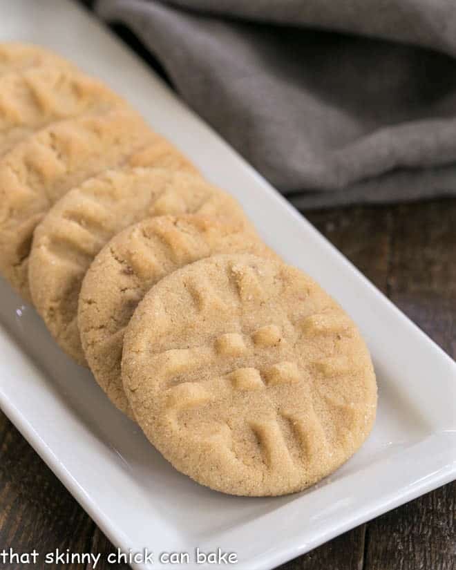 Best Peanut Butter Cookies - An exquisite cookie with the perfect snap and a bit of texture from extra chunky peanut butter! Homemade Peanut Butter Cookies on a white ceramic tray.