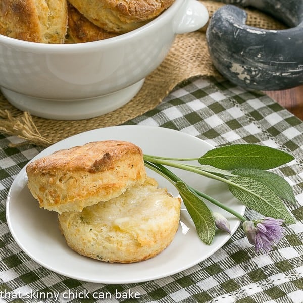 Herbed Buttermilk Biscuits on a white plate with sage and chives.