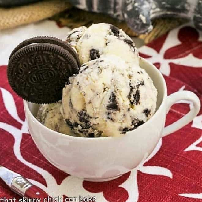 White cup of Oreo Ice cream on a red and white napkin.