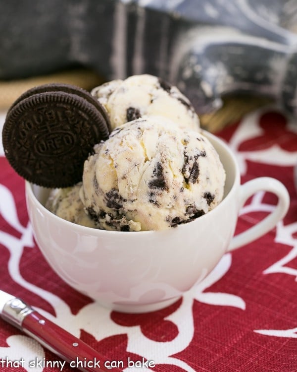 Oreo Ice Cream scoops in a tea cup garnished with an Oreo.