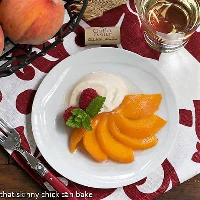 Overhead view of Poached peach fanned out on a white dessert plate.
