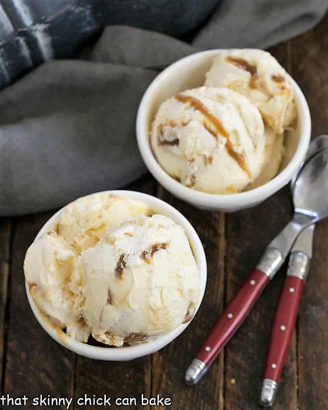 Overhead view of 2 small white bowls of caramel ice cream.