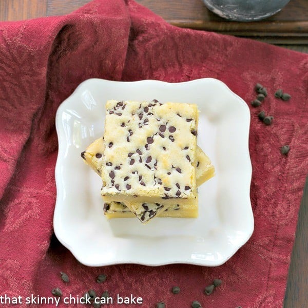 Overhead view of White Chocolate Brownies stacked on a white dessert plate