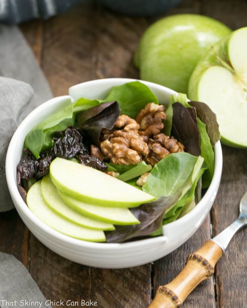 Apple, Cherry, Walnut Salad with Maple Dressing in a white salad bowl