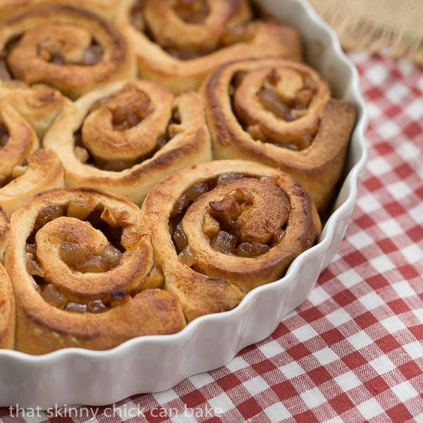 Unfrosted Apple Cinnamon Rolls in a round white baking dish
