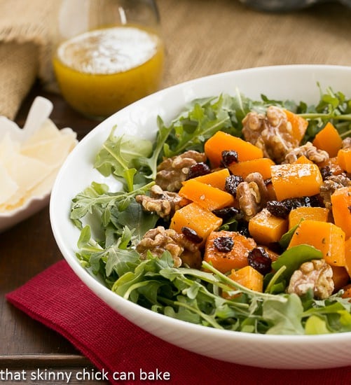 Arugula Salad with Roasted Butternut Squash in a white salad bowl.