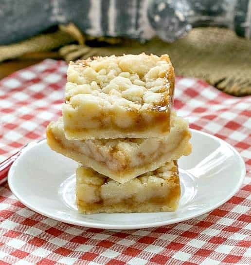 Caramel Butter Bars stacked on a small, white round plate