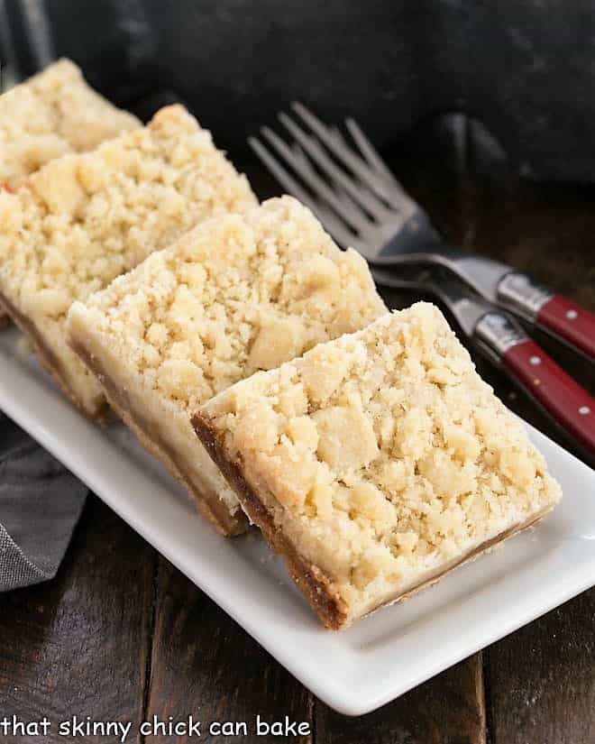 Caramel Butter Bars lined up on a narrow white tray.