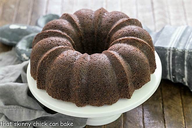 Chocolate Zucchini Bundt Cake on a white cake stand