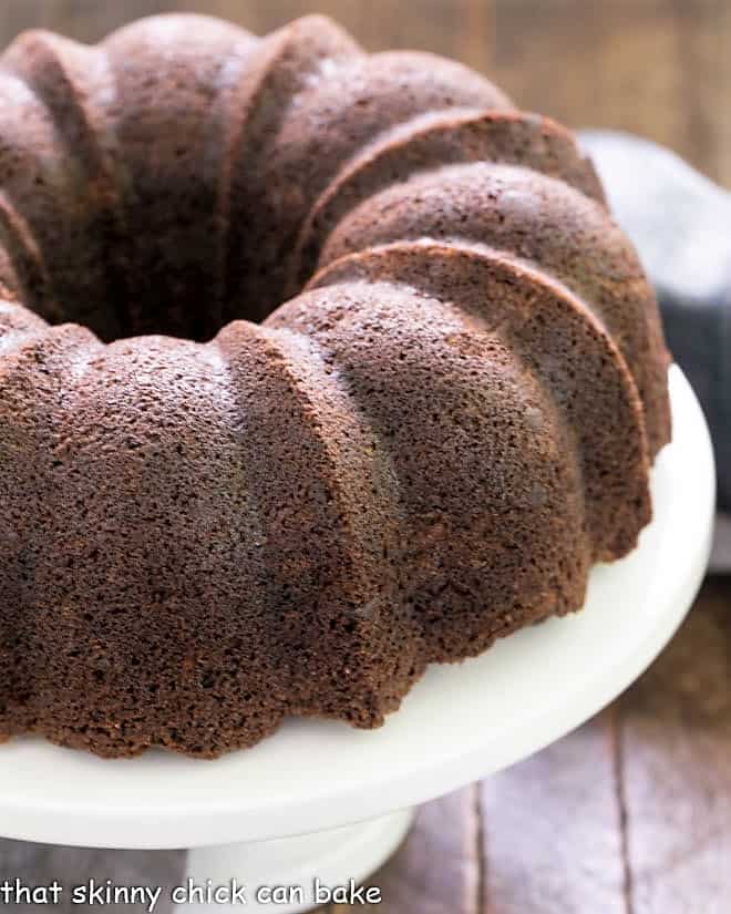 Chocolate Zucchini Bundt Cake on a white cake plate.