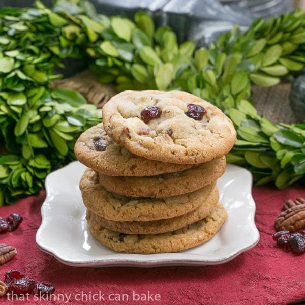 Cranberry, White Chocolate, Crystallized Ginger Cookies stacked on a white plate.