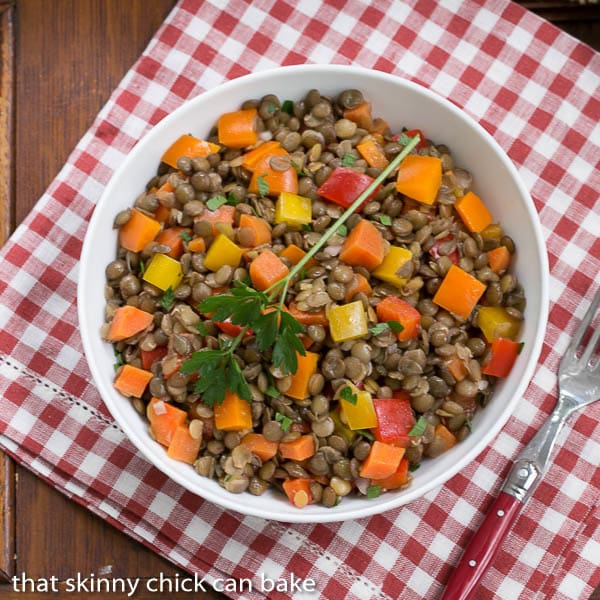 French Lentil Salad - Lentils tossed with a lovely mustard vinaigrette French Lentil Salad in a white bowl on a red and white checked napkin
