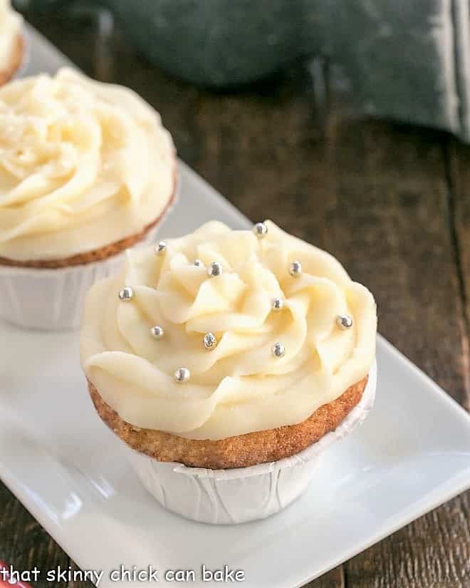 vanilla cupcakes on a white tray.