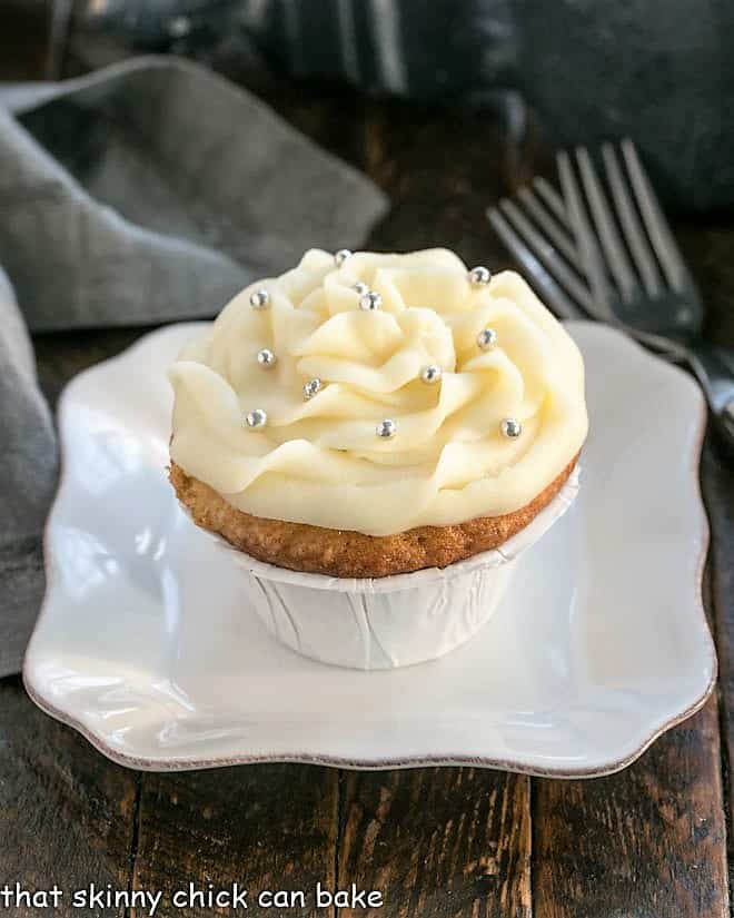 Vanilla cupcake on a square white plate.