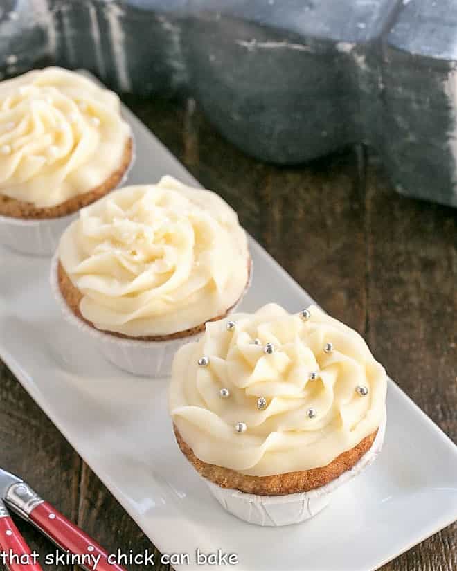 Vanilla Cupcakes with Cream Cheese Frosting on a white rectangular tray.