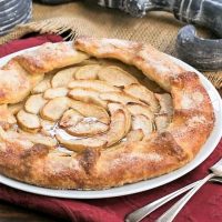 Maple Glazed Apple Galette on a white serving plate on a red napkin