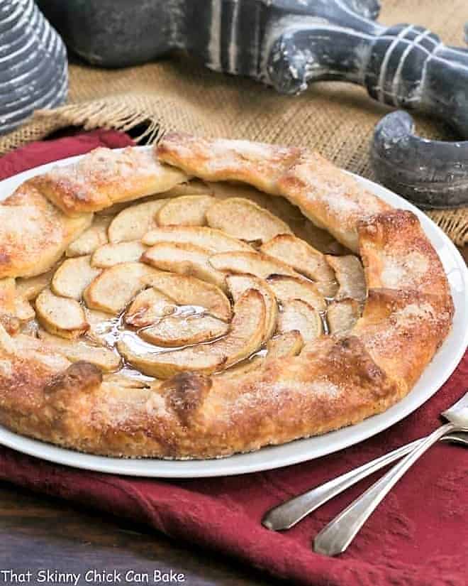 Maple Glazed Apple Galette on a white serving plate on a red napkin