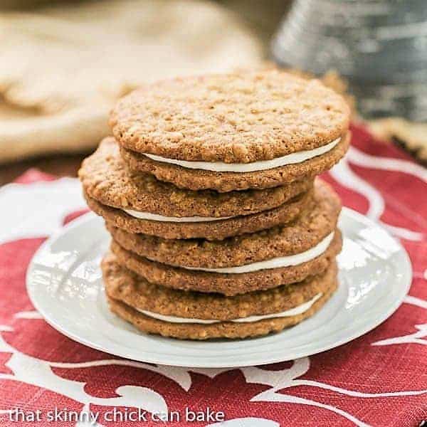 Oatmeal Creme Pies - Better than Little Debbies!!! Two chewy oatmeal cookies with a luscious creamy filling! A white tray full of Oatmeal Creme Pies.
