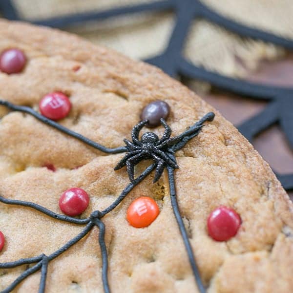 Spiderweb Cookie Cake close up of web and plastic spider.