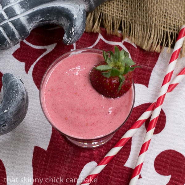 Overhead view of a Berry Smoothie with two red and white straws