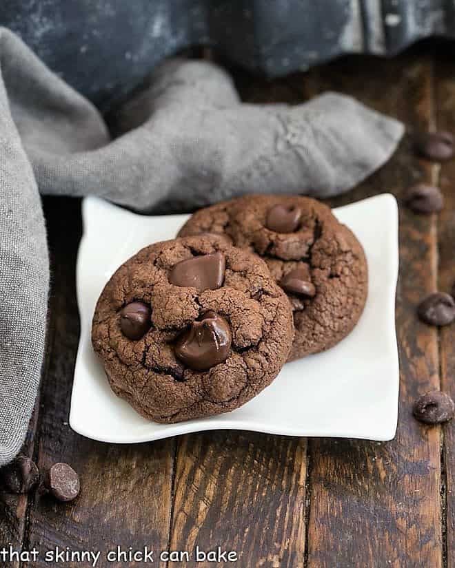 Two Double Chocolate Chunk Cookies on a square white plate