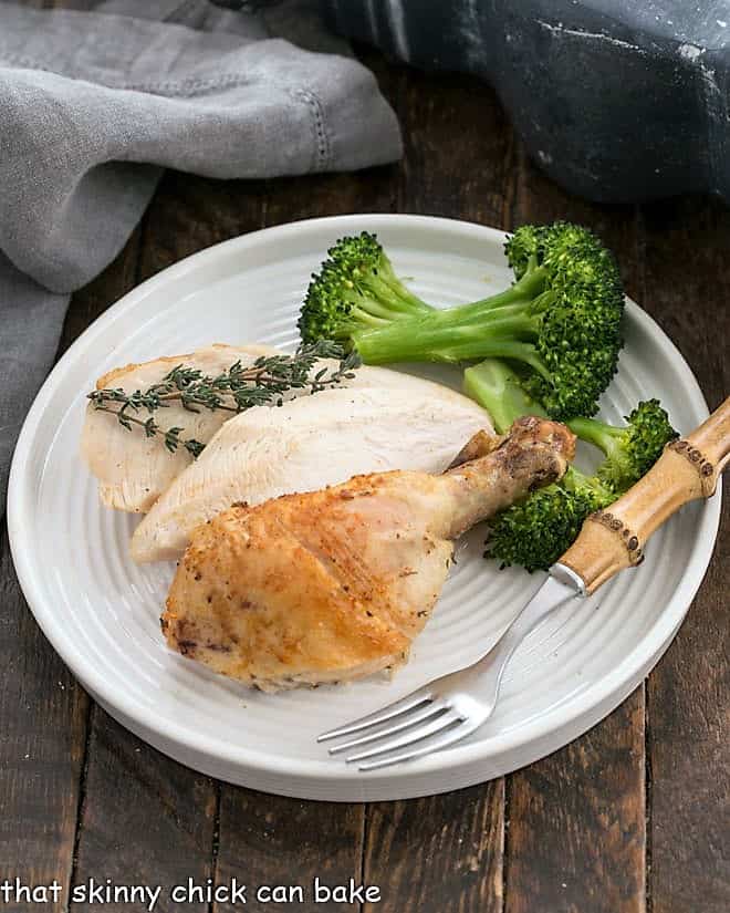 Overhead view of Rotisserie Style Chicken on a round white dinner plate.